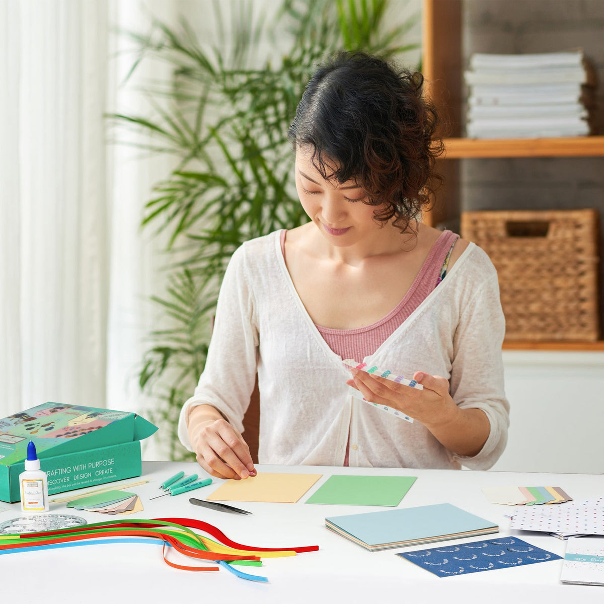 Example of an adult embellishing a greeting card with My Creative Camp quilling kit materials