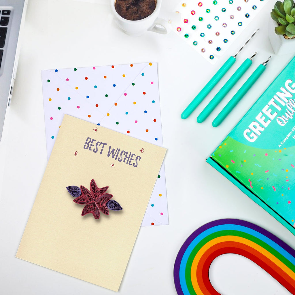 Example quilled greeting card and envelope beside My Creative Camp tools, paper strips and kit box