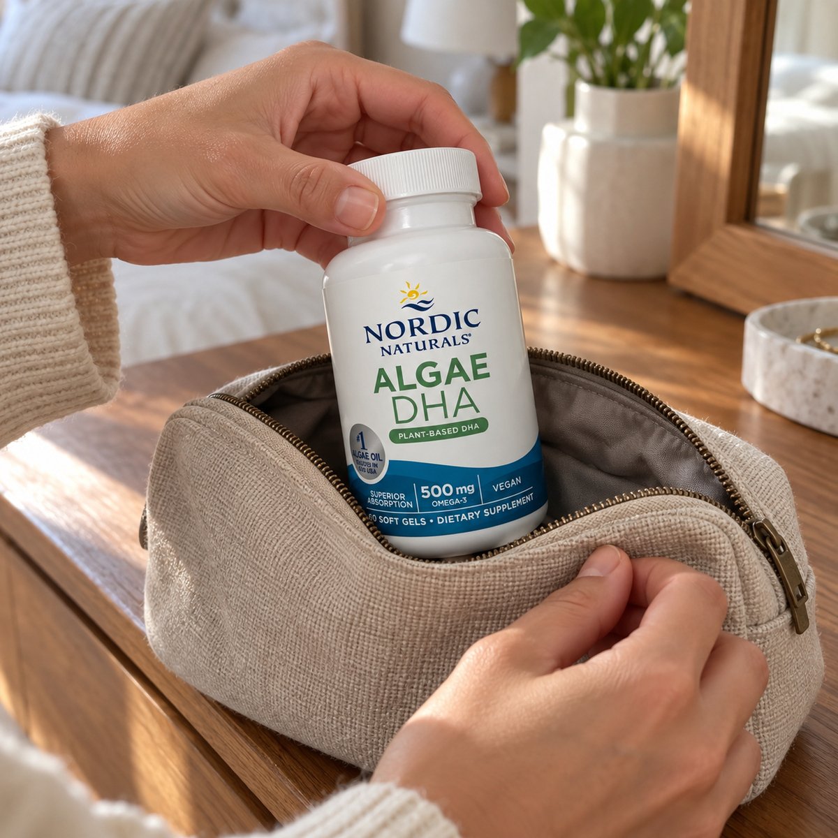 An adult packing a Nordic Naturals Algae DHA 60-soft-gel bottle in a fabric travel pouch