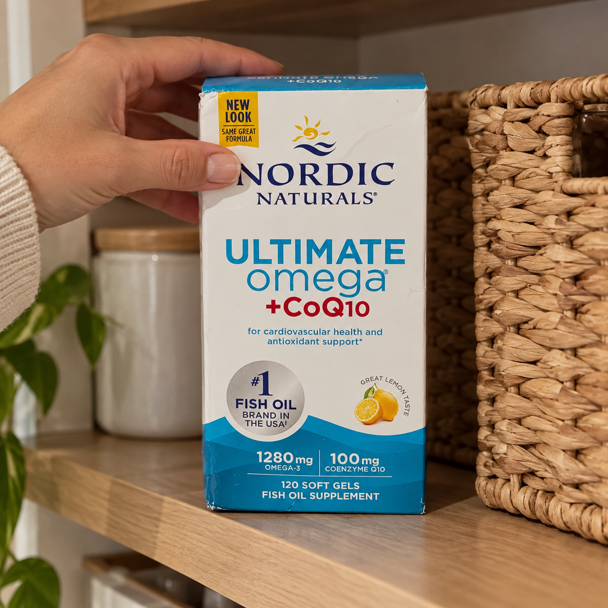 Nordic Naturals Ultimate Omega + CoQ10 120-soft-gel box being placed on a pantry shelf