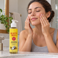 AI-generated illustration of an adult massaging dry cheeks beside one Burt's Bees Coconut and Argan Cleansing Oil 6 fl oz bottle.