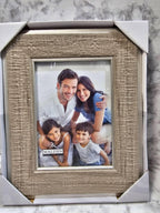 Family photo in a textured picture frame on a marble surface