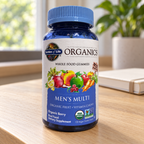 Garden of Life Organics Men's Multi 120-gummy bottle on a home study desk