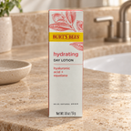 Burt's Bees Hydrating Day Lotion carton on a travertine vanity, AI-assisted illustration