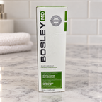 BosleyMD Follicle Energizer carton on a pale stone vanity beside folded towels
