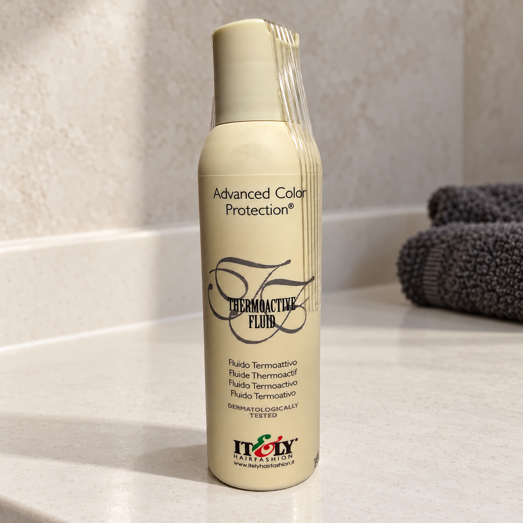 Itely Thermoactive Fluid bottle on a pale stone vanity with a charcoal towel behind