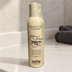 Itely Thermoactive Fluid bottle on a pale stone vanity with a charcoal towel behind