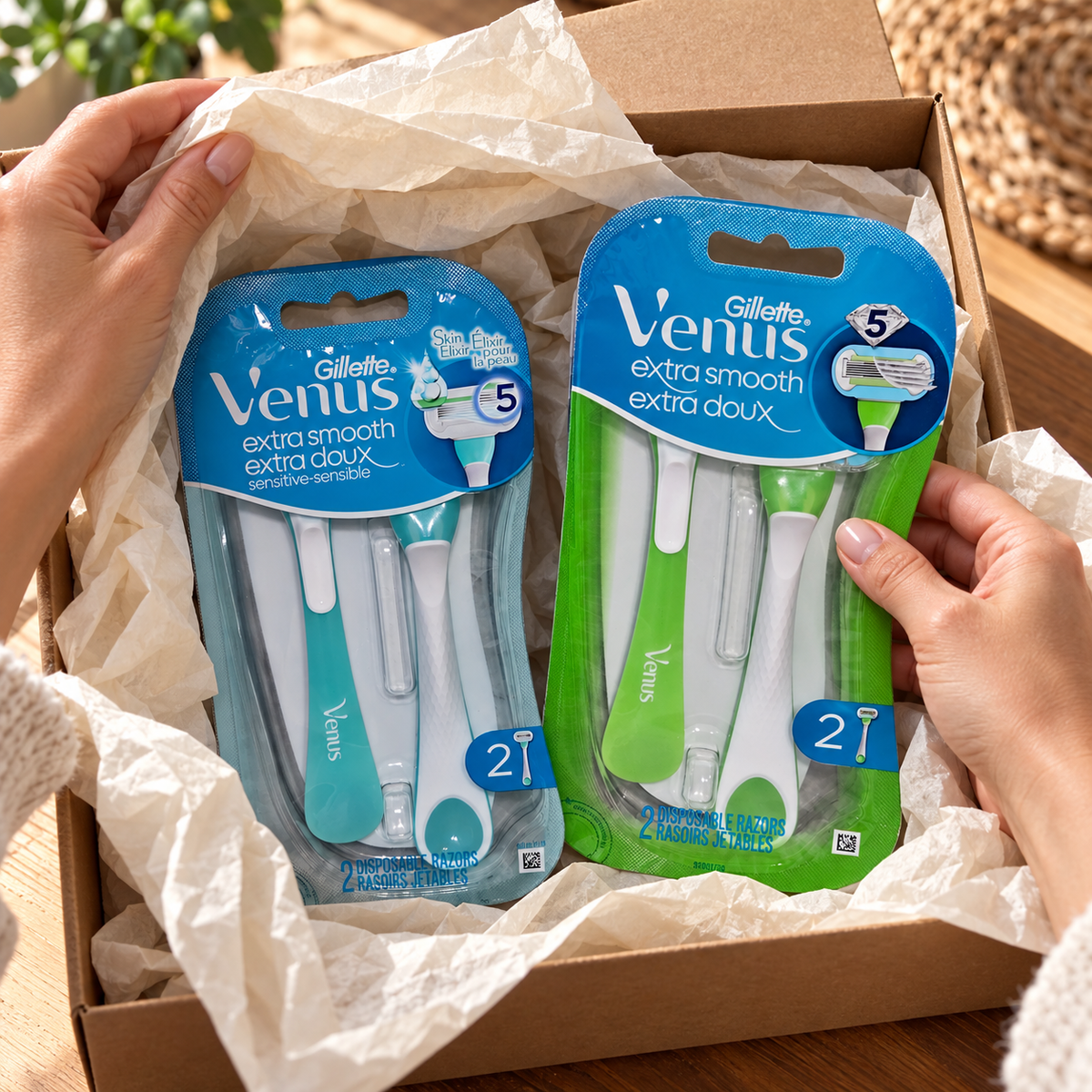Adult opening a gift containing the green Venus Extra Smooth and teal Extra Smooth Sensitive two-razor packs