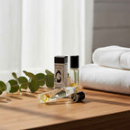 Vixen crystal essential oil roller bottle and packaging beside folded towels, showing the roll-on format
