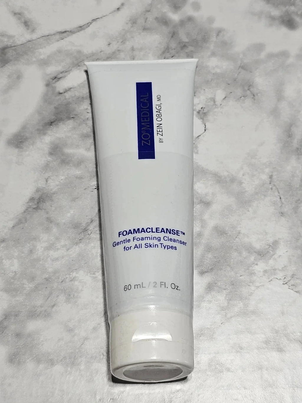 Tube of ZO Medical Foamacleanse Gentle Foaming Cleanser on a marble background