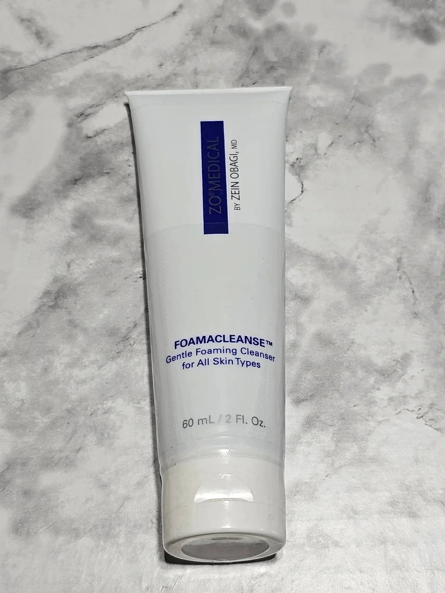 Tube of ZO Medical Foamacleanse Gentle Foaming Cleanser on a marble background