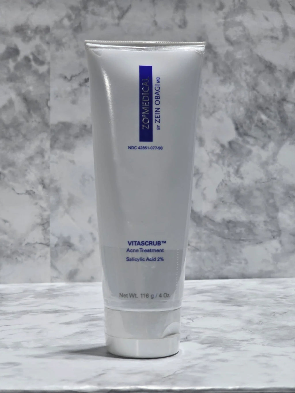 Tube of Vitanails nail and cuticle cream on a marble surface