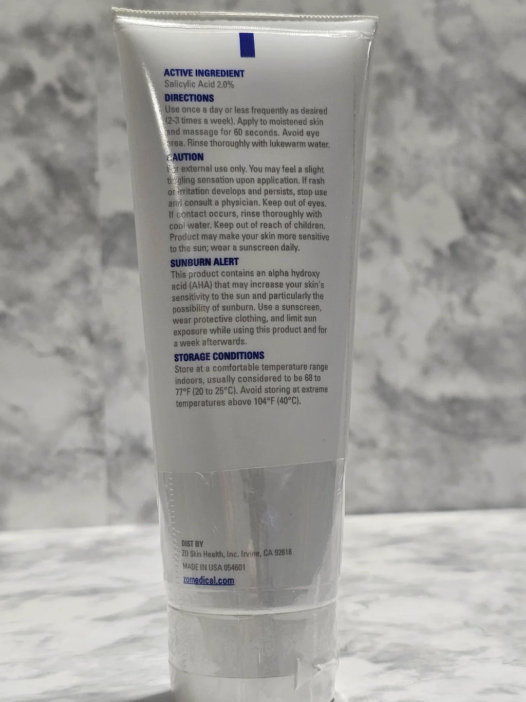 Tube of skincare product on a marble surface