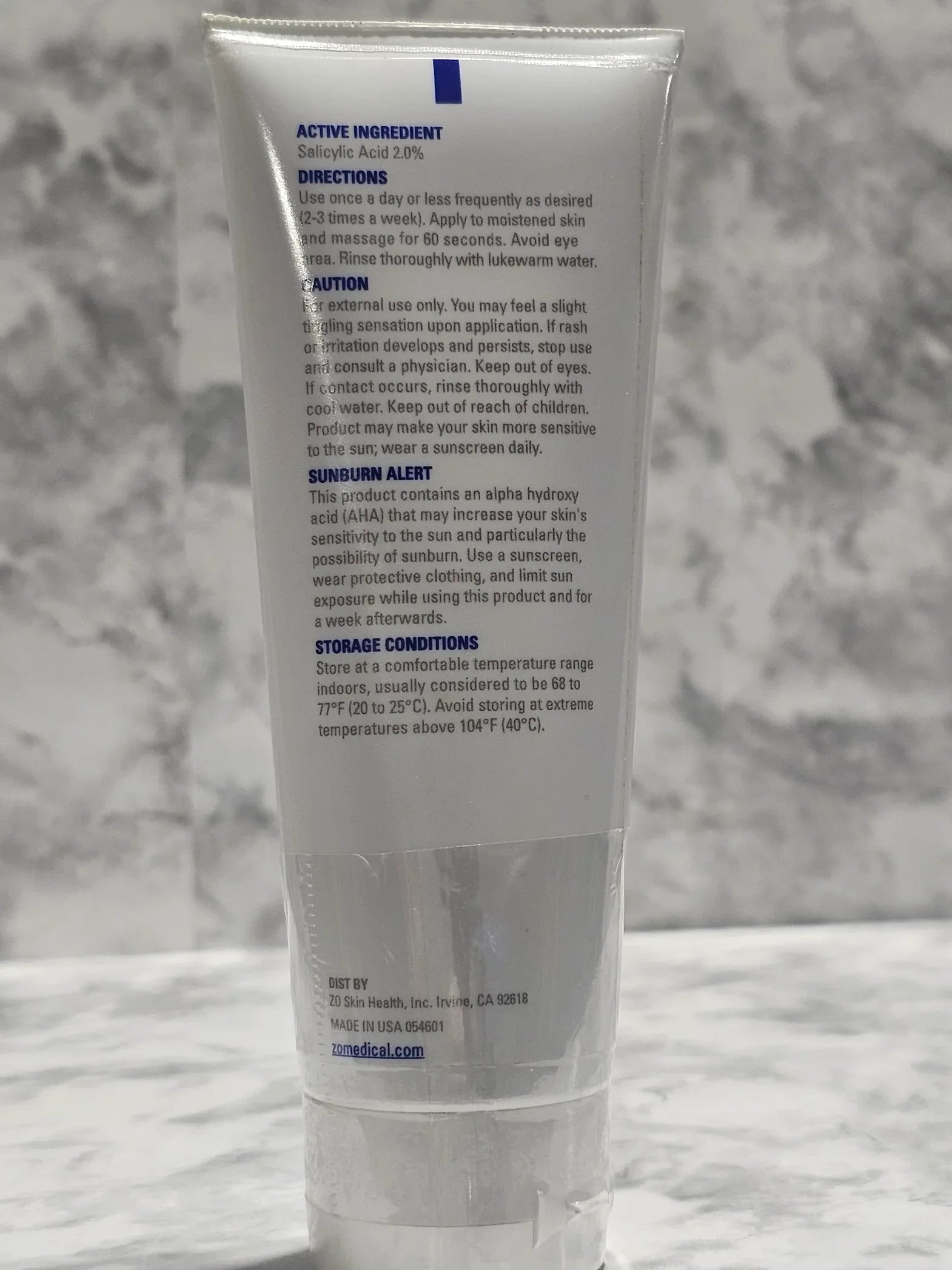 Tube of skincare product on a marble surface