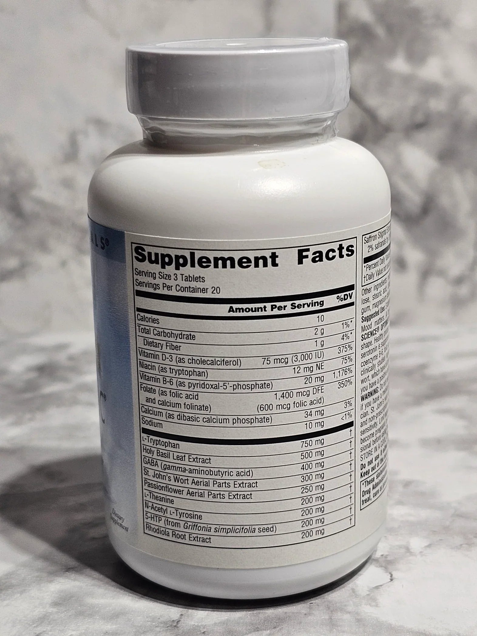 Supplement bottle with label on a marble surface