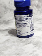 Supplement bottle with label on a white textured background