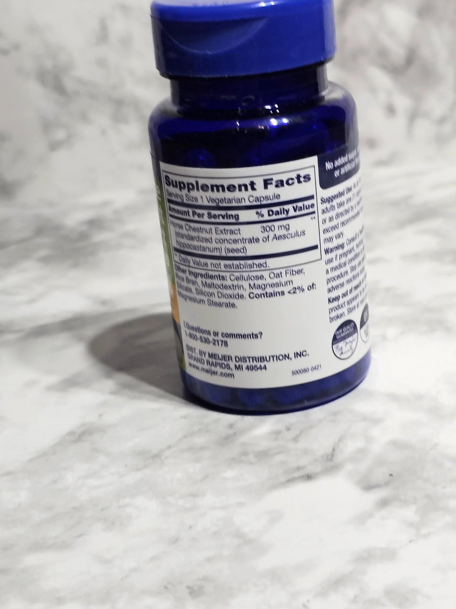 Supplement bottle with label on a white textured background