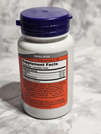 Supplement bottle with label on a marble surface