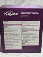Purple box of Women's Rogaine hair regrowth treatment on a marble surface