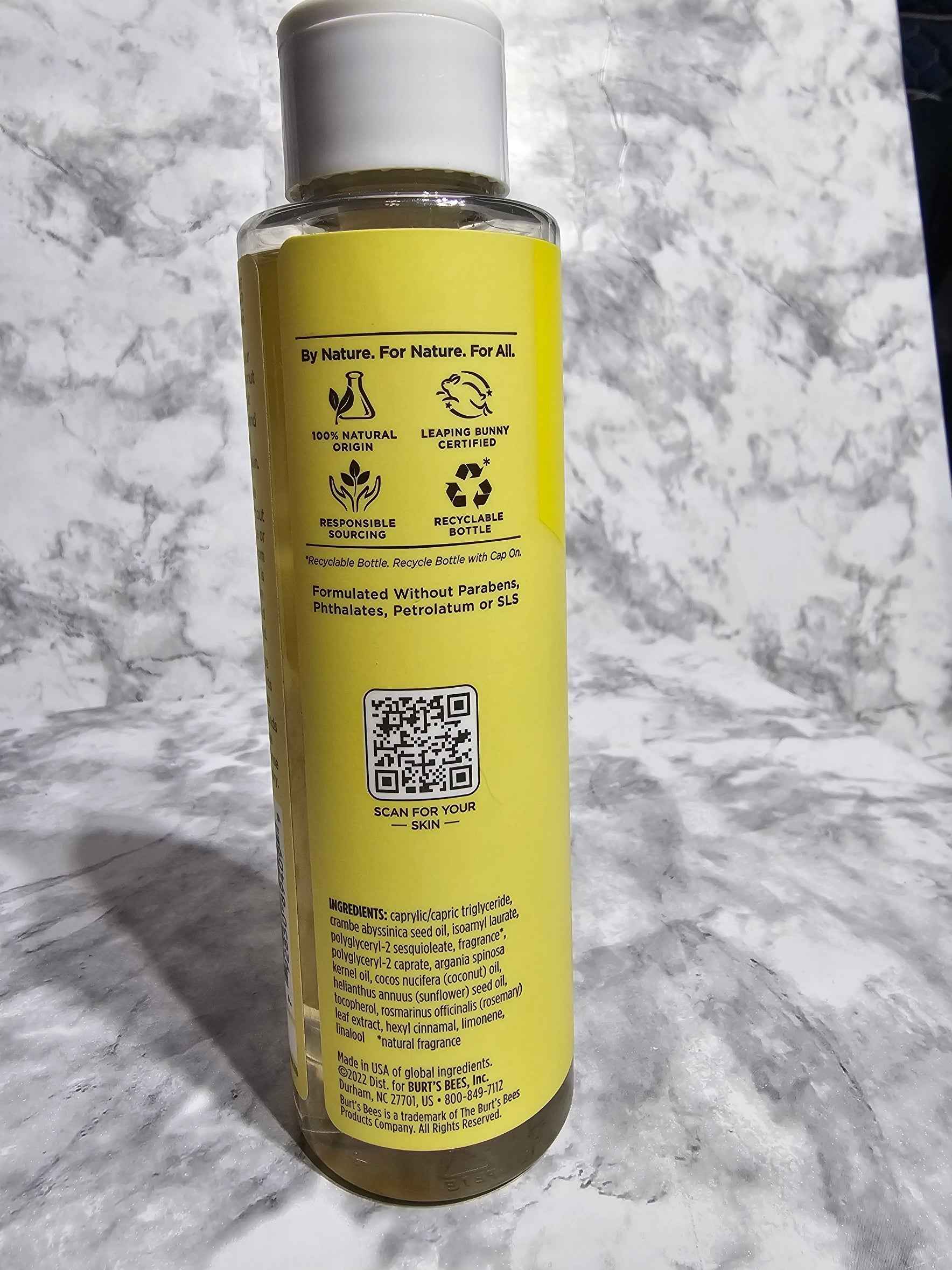 Yellow bottle with label on a marble surface