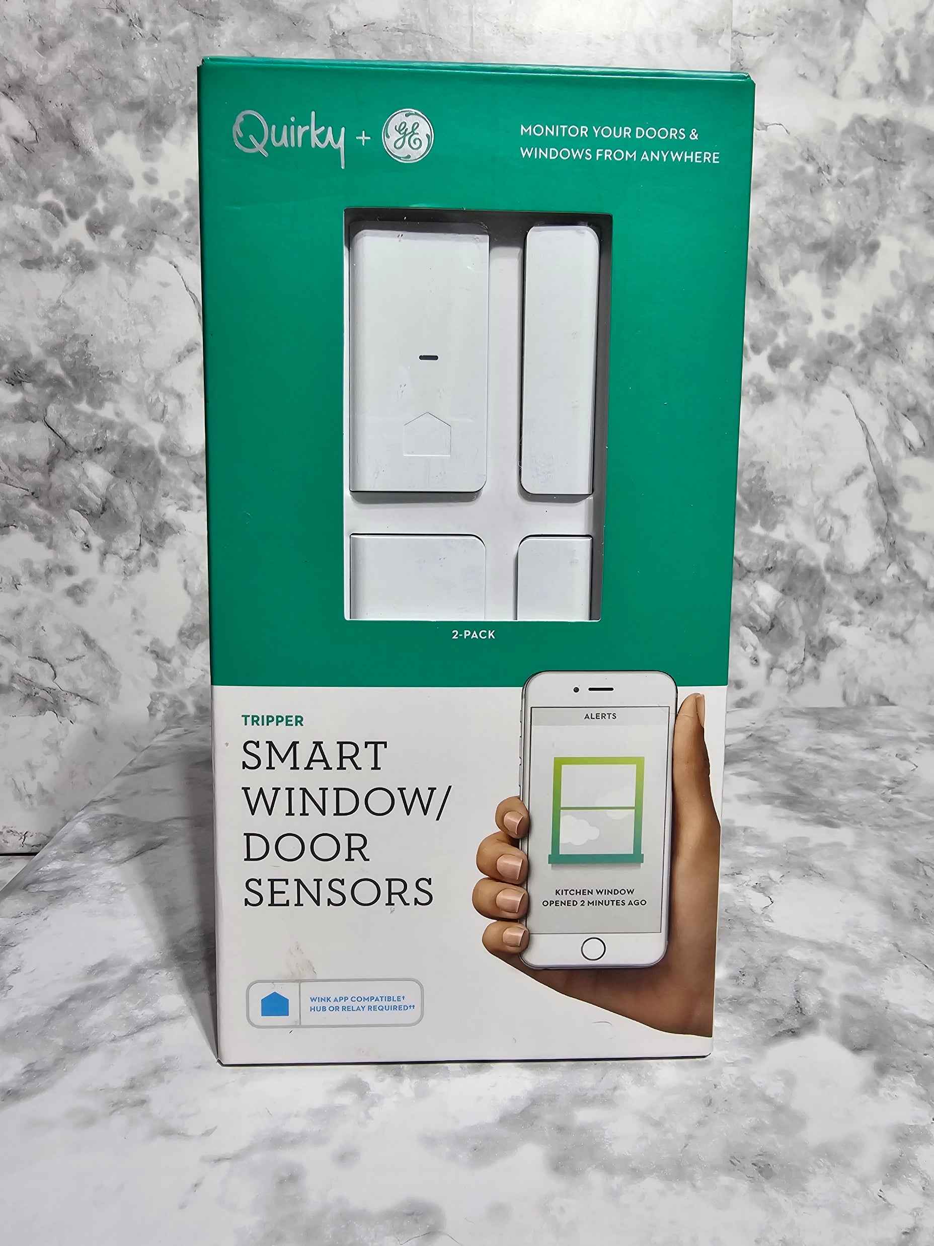 Quirky smart window/door sensors packaging on a marble surface