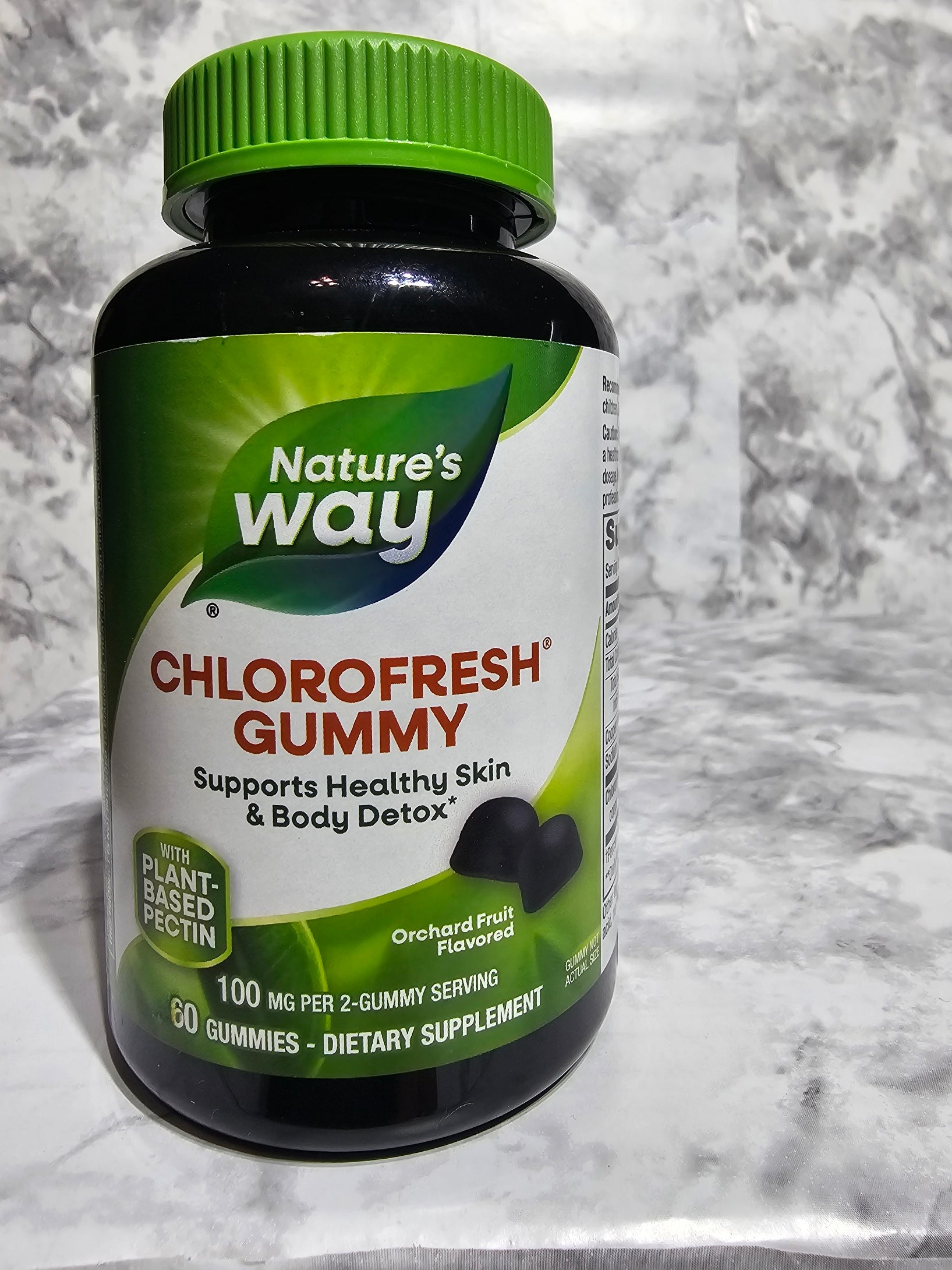 Nature's Way Chlorofresh Gummy supplement bottle on a gray surface