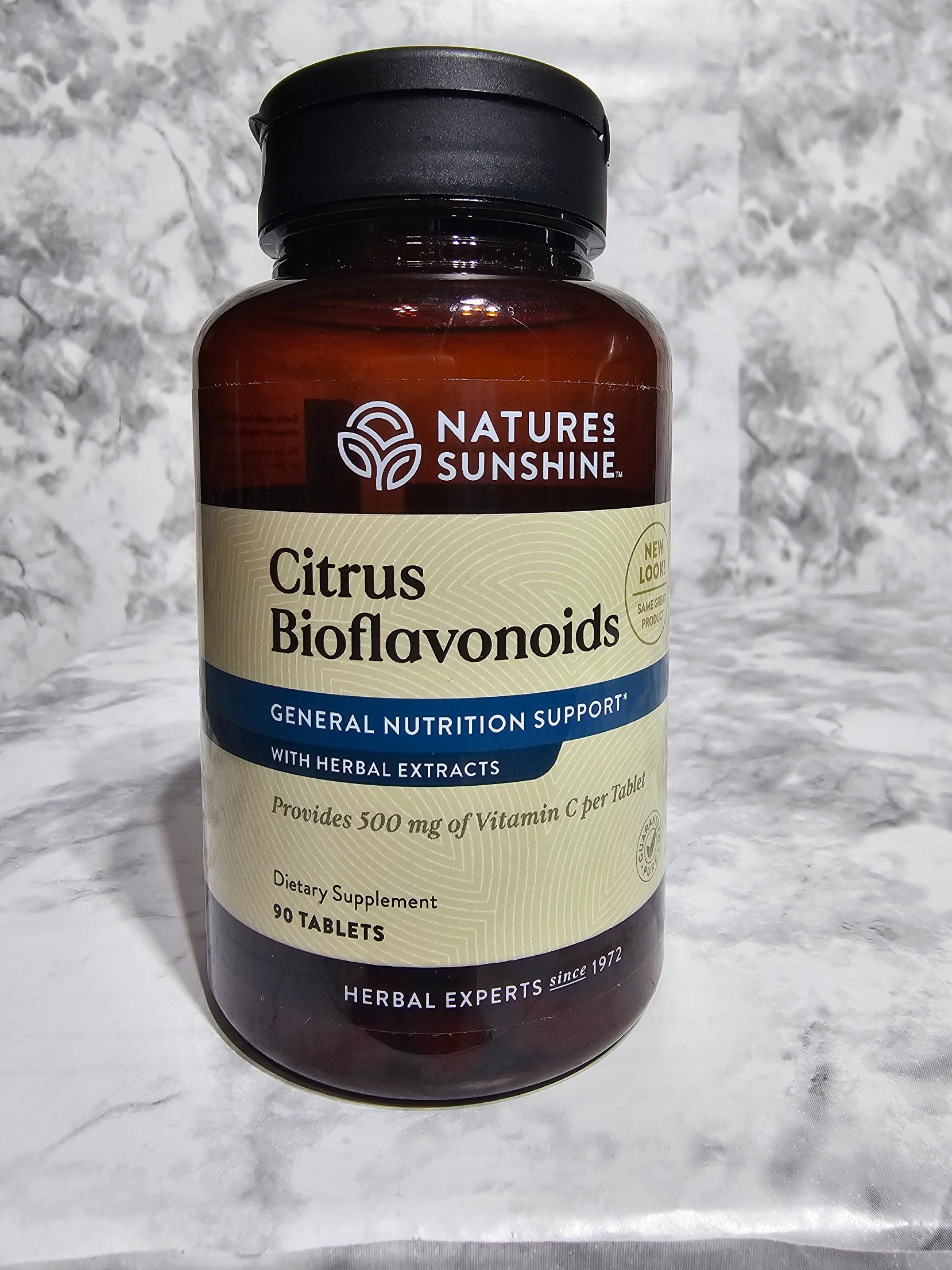 Nature's Sunshine Citrus Bioflavonoids bottle on a marble surface