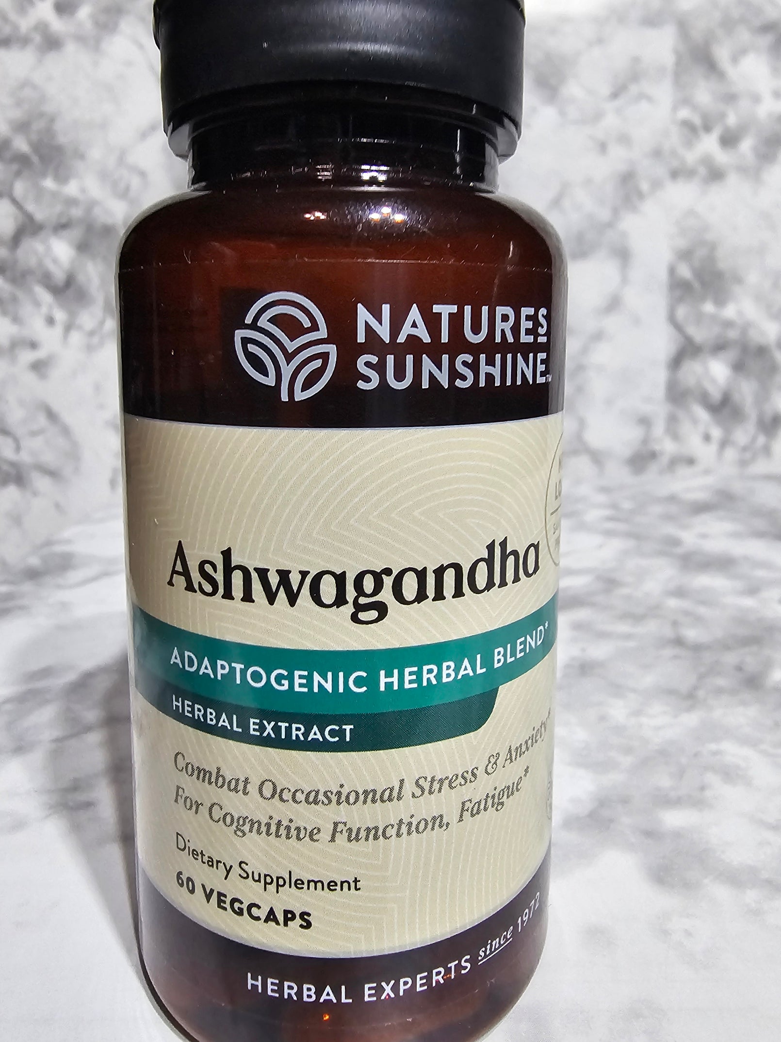 Nature's Sunshine Ashwagandha bottle on a gray surface