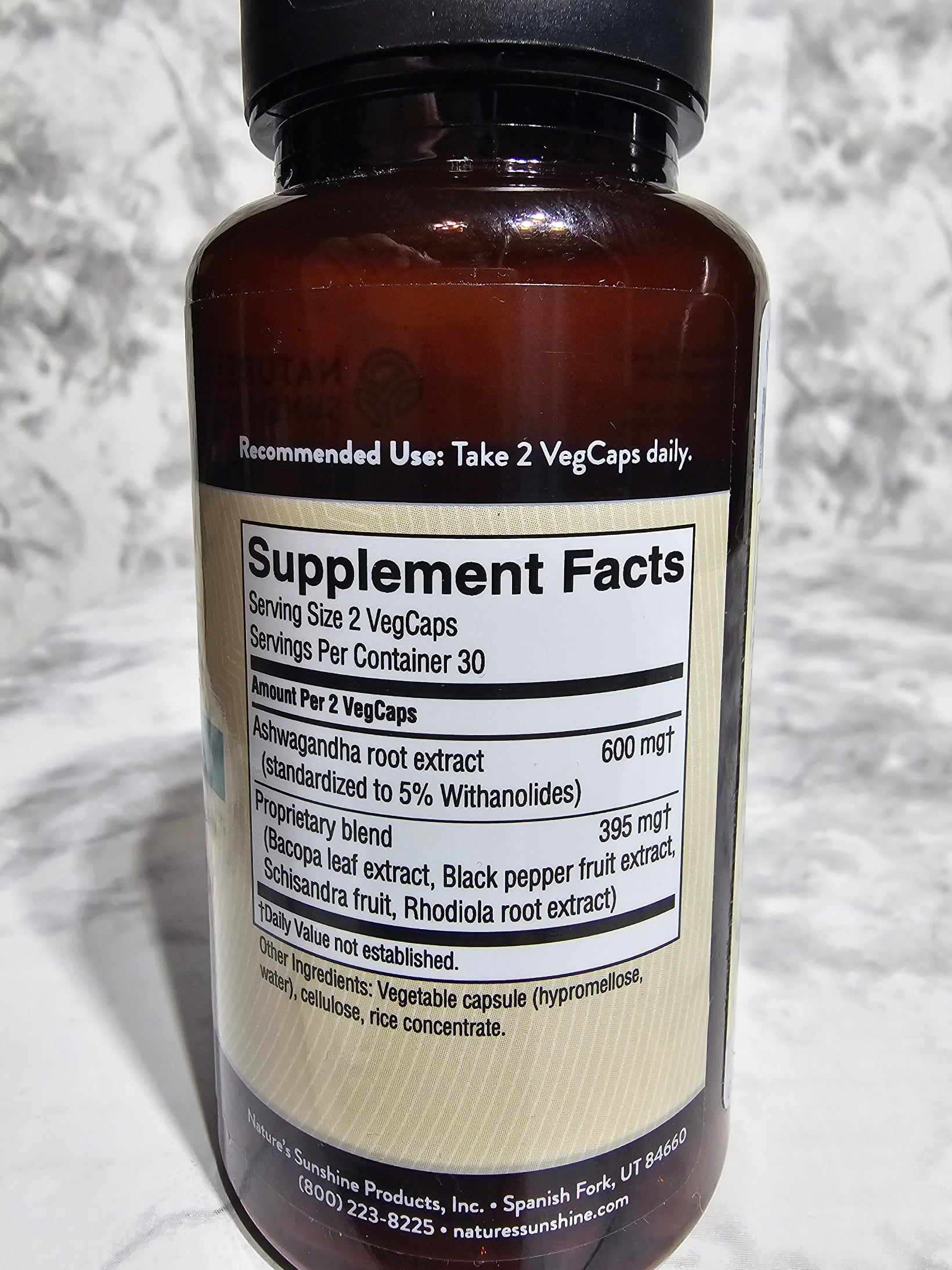 Supplement bottle with label on a textured surface