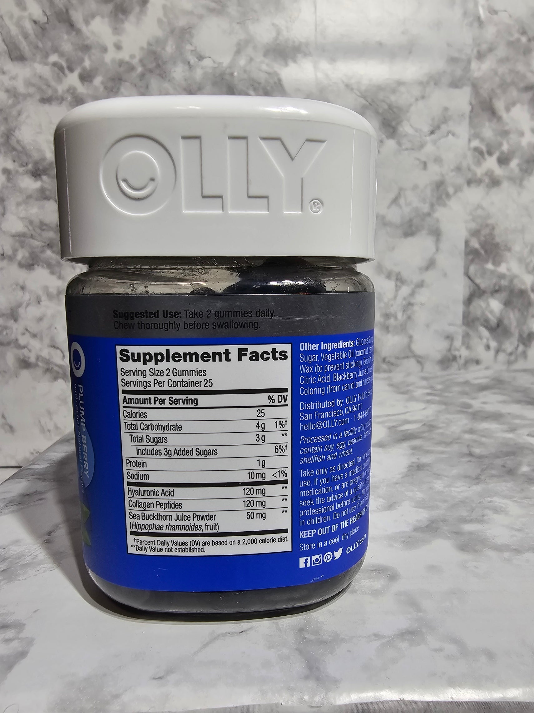 Supplement bottle with blue label on a marble surface