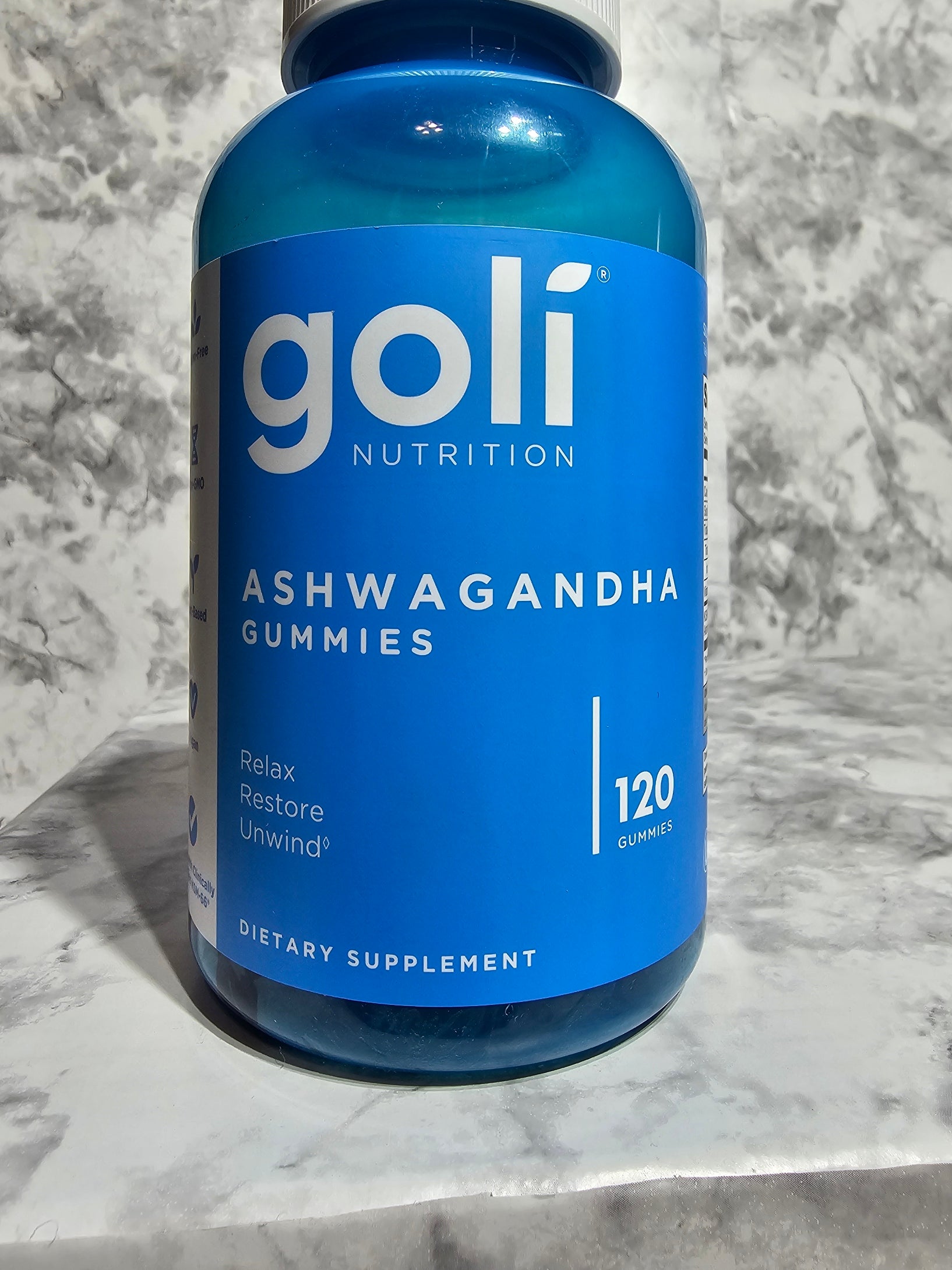 Blue bottle of golfi Nutrition Ashwagandha gummies on a marble surface