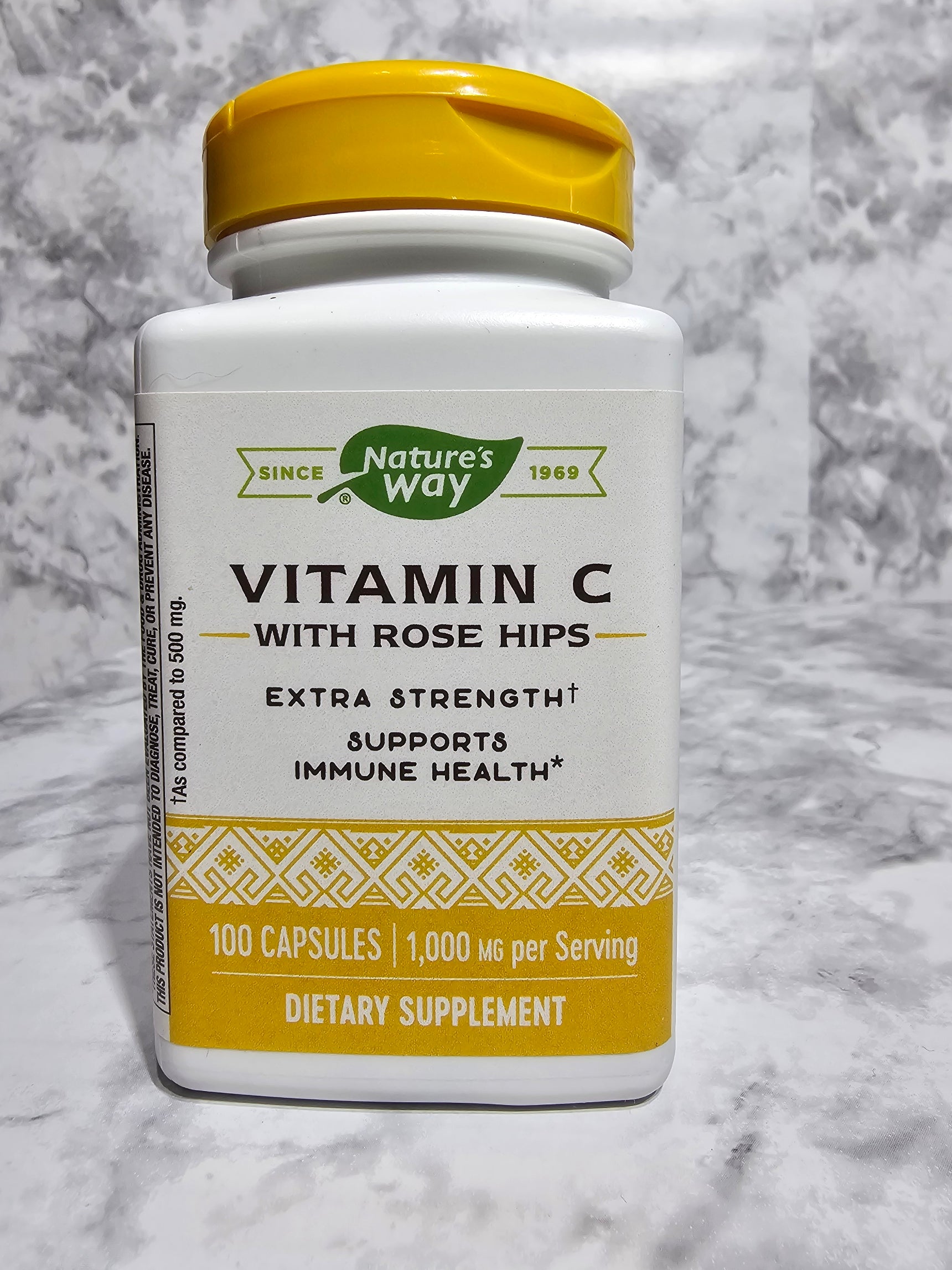 Nature's Way Vitamin C with Rose Hips supplement bottle on a marble surface