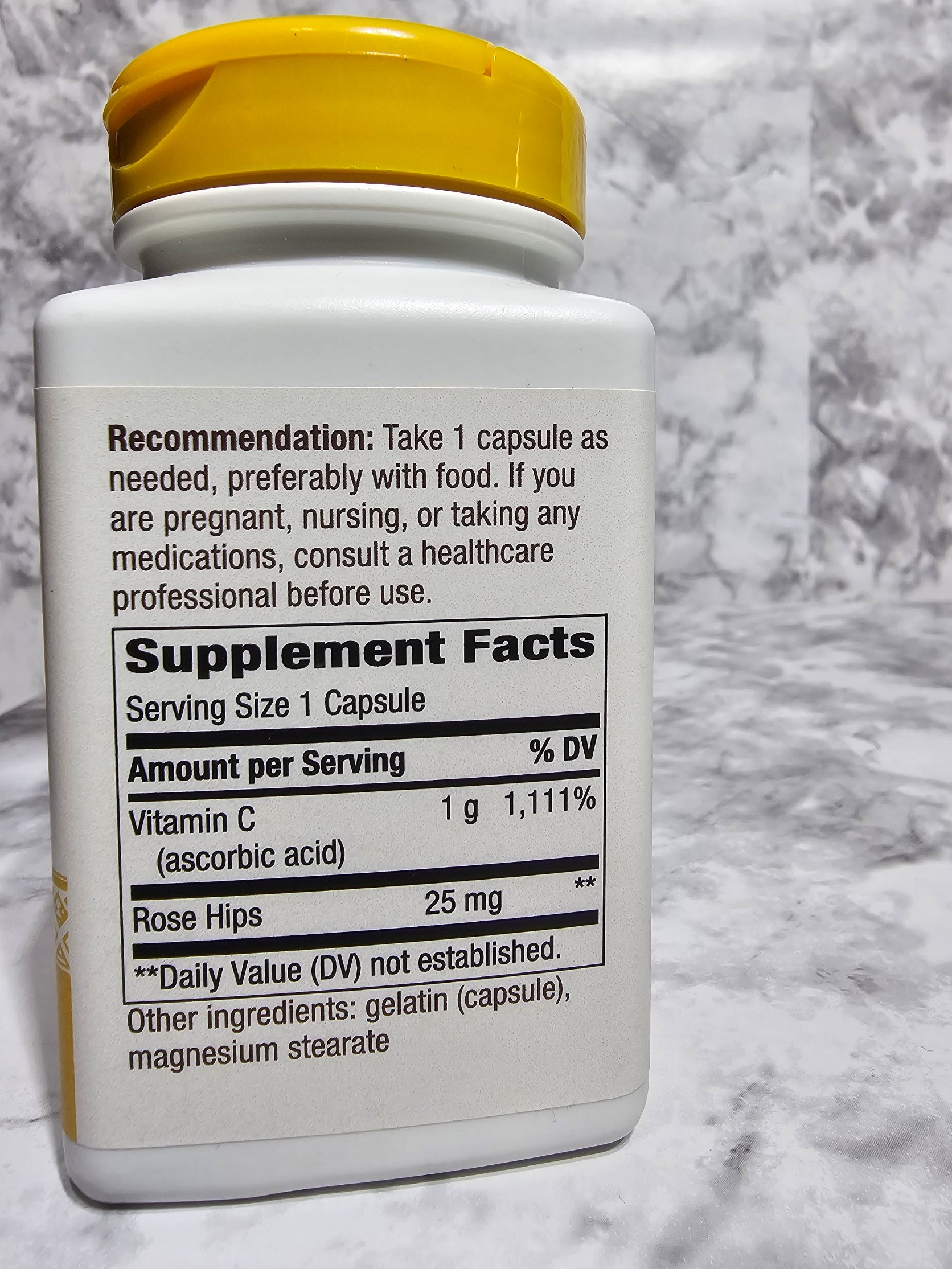 Supplement bottle with label on a marble surface