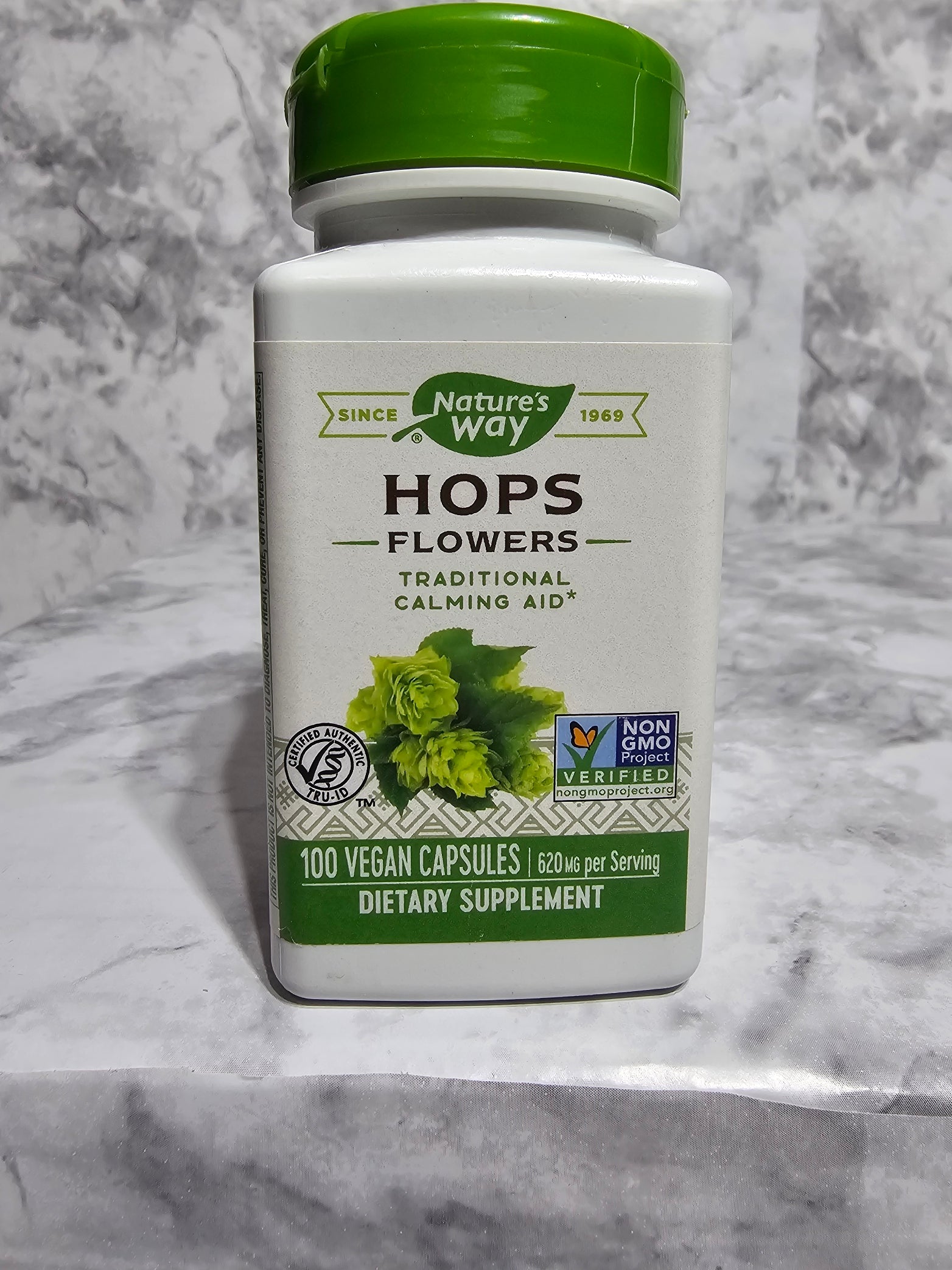Supplement bottle labeled 'Hops Flowers' by Nature's Way on a marble surface