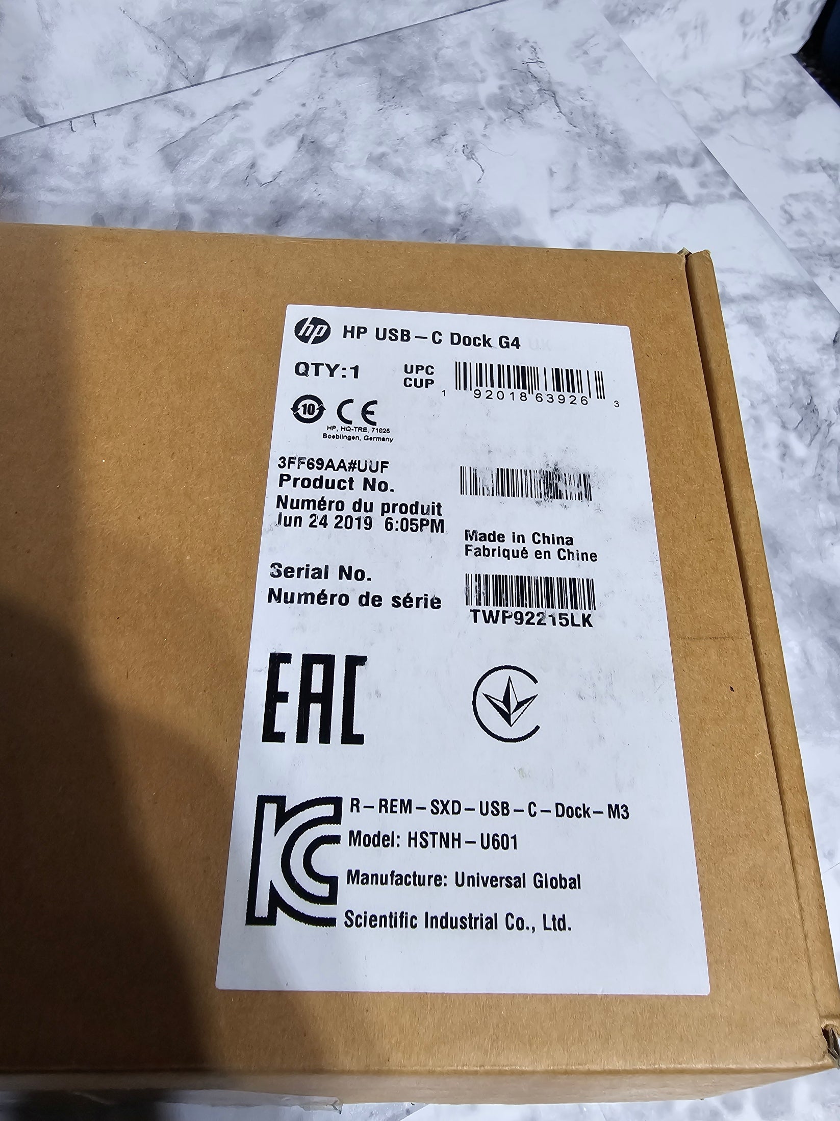 Cardboard box with a label on a marble surface