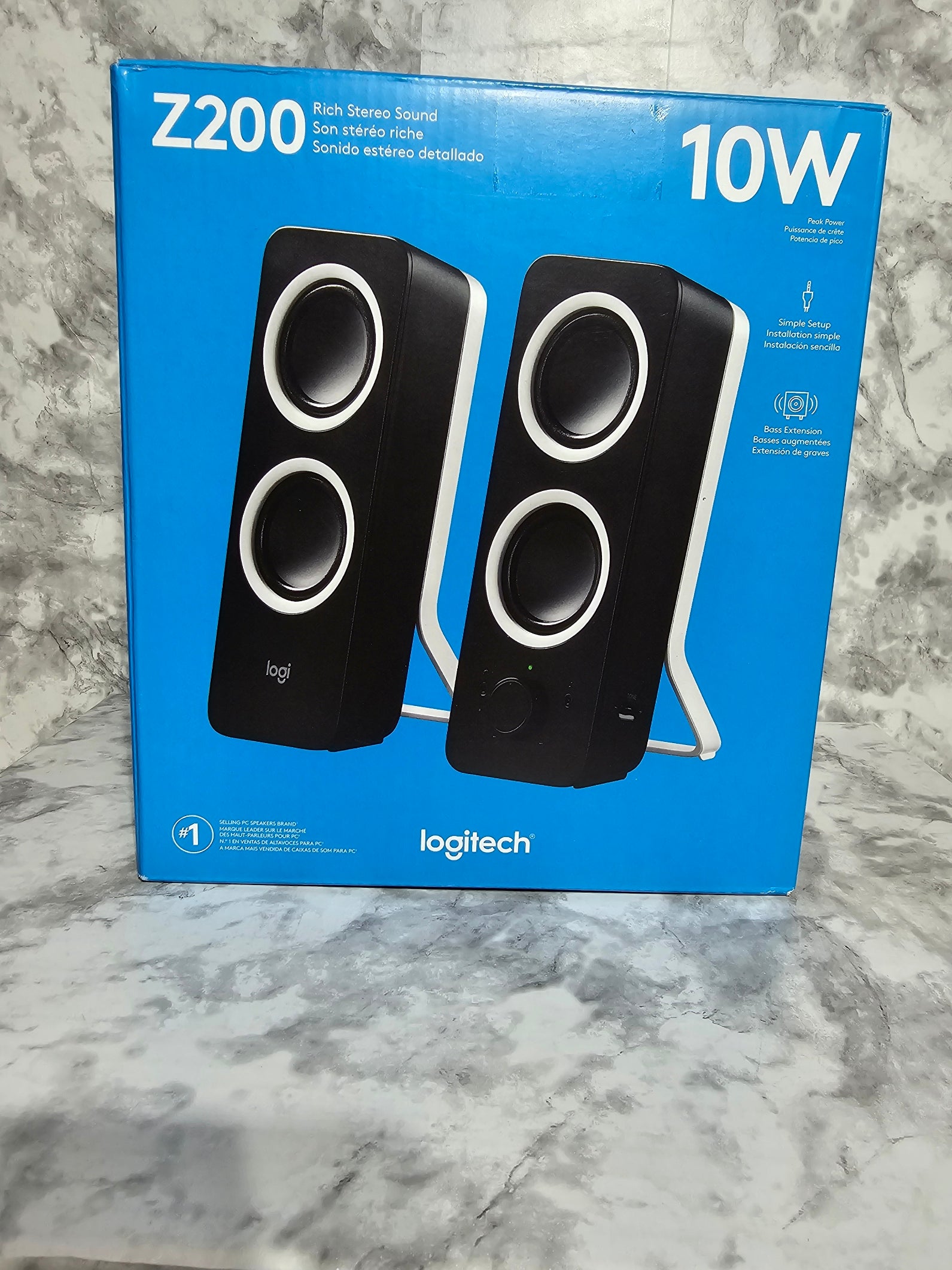 Logitech Z200 speaker system packaging on a marble surface