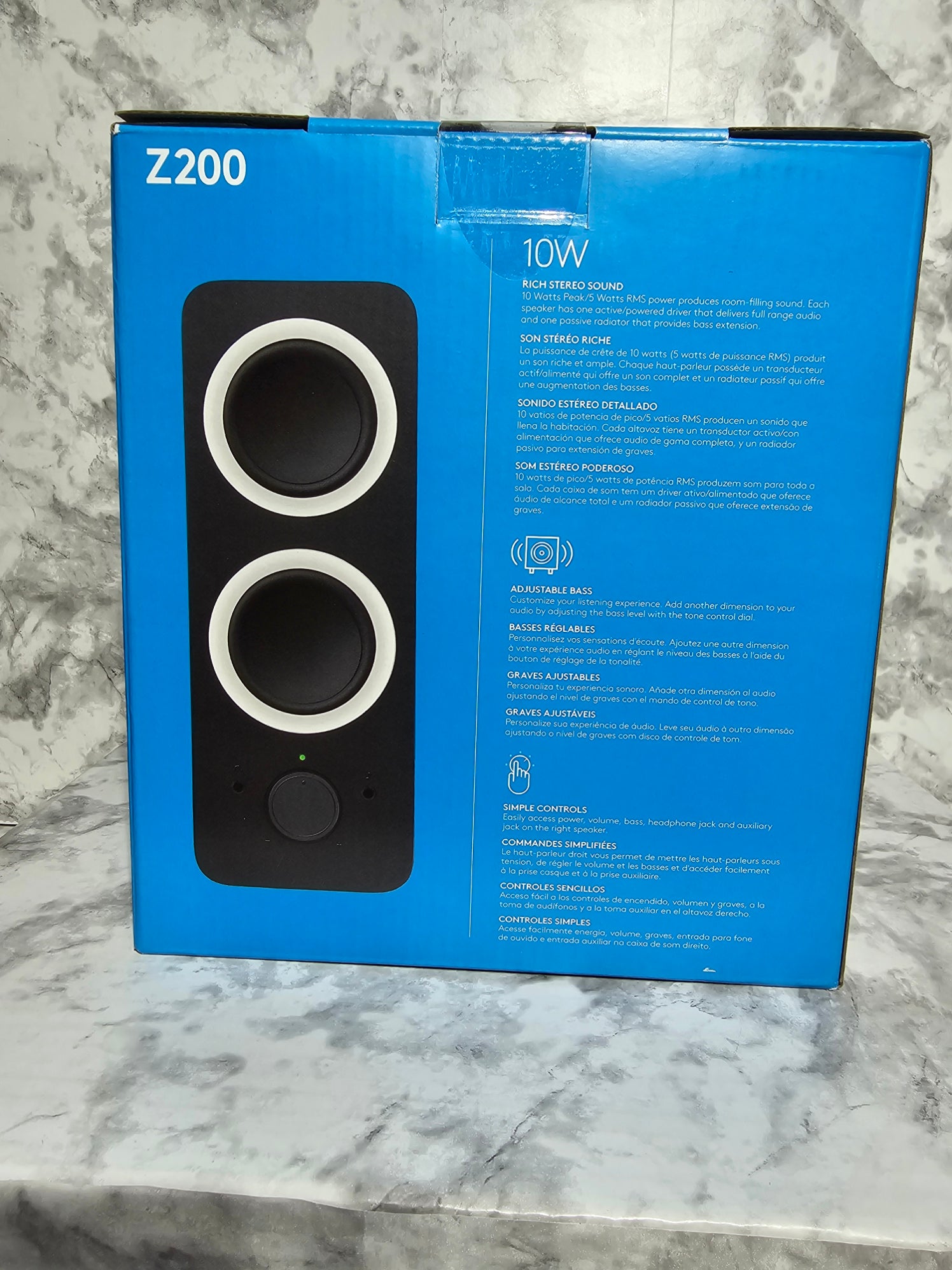 Blue box with a black and white device illustration on a marble surface