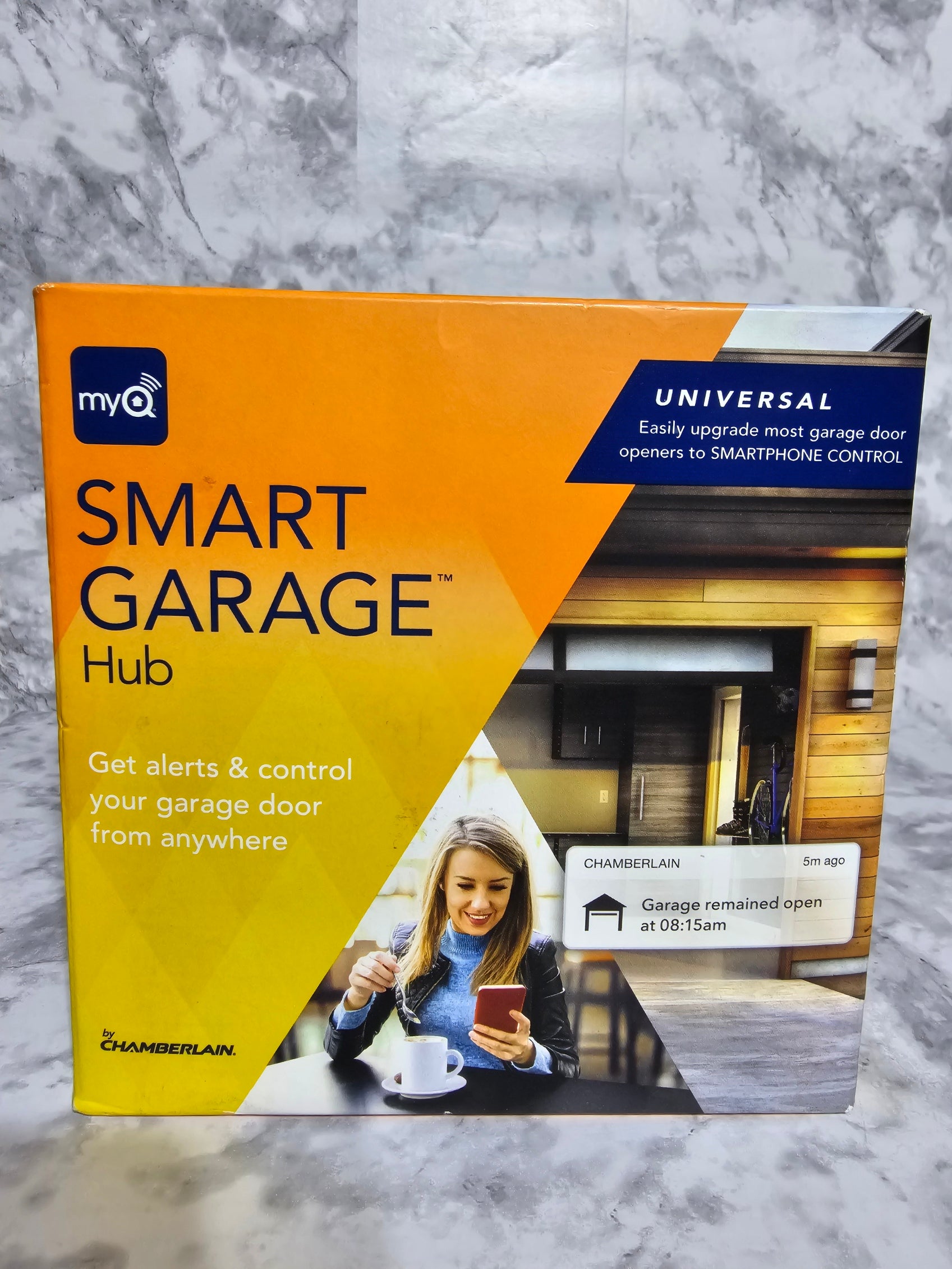 MyQ Smart Garage Hub packaging on a marble surface