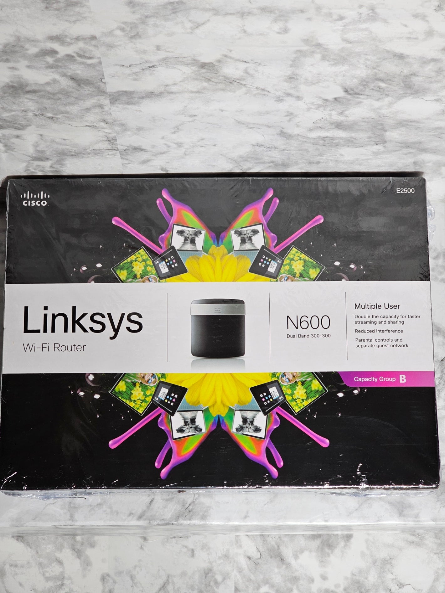 Linksys router packaging on a gray marble surface