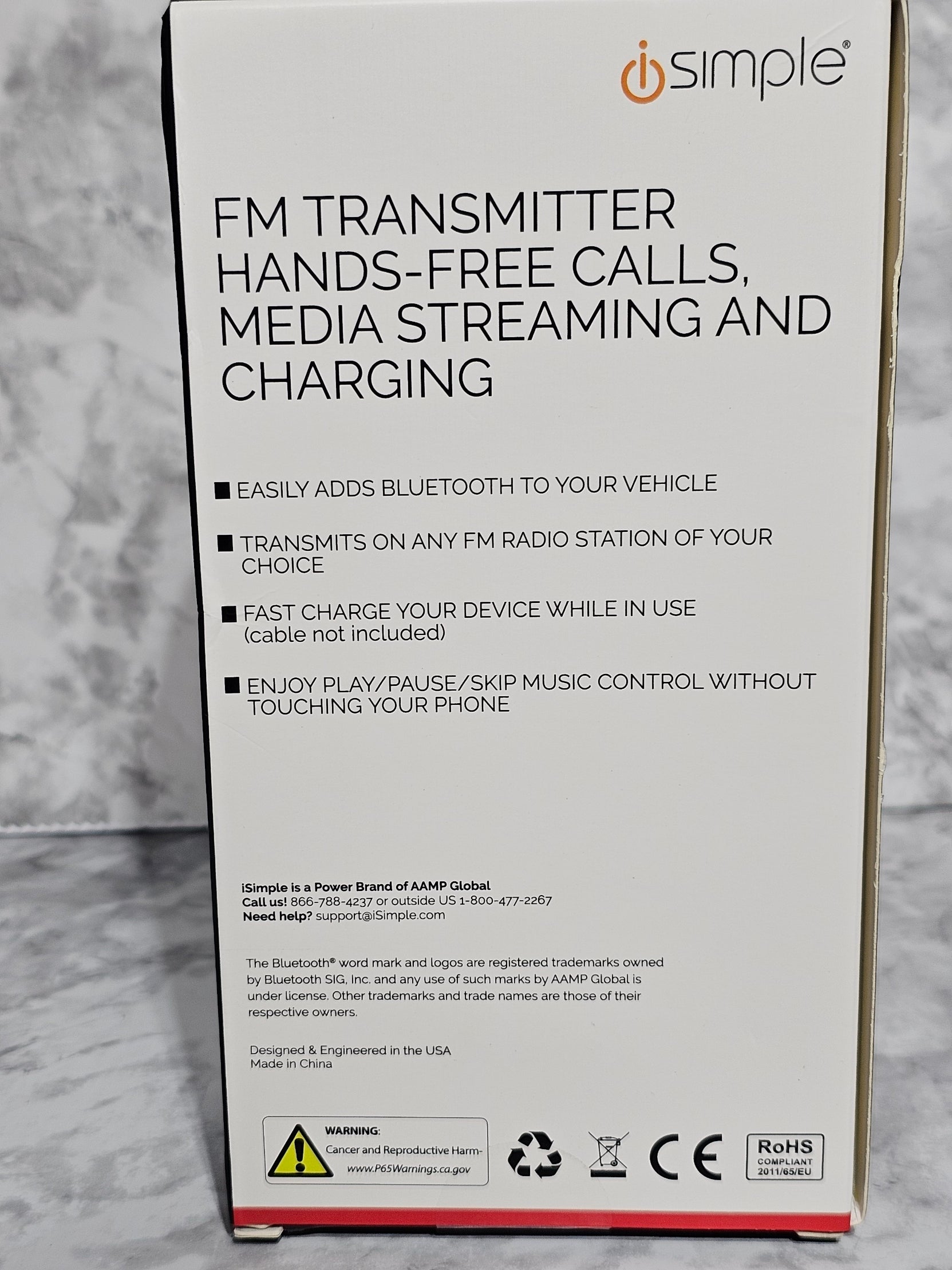 Box for an FM transmitter with text on a gray surface