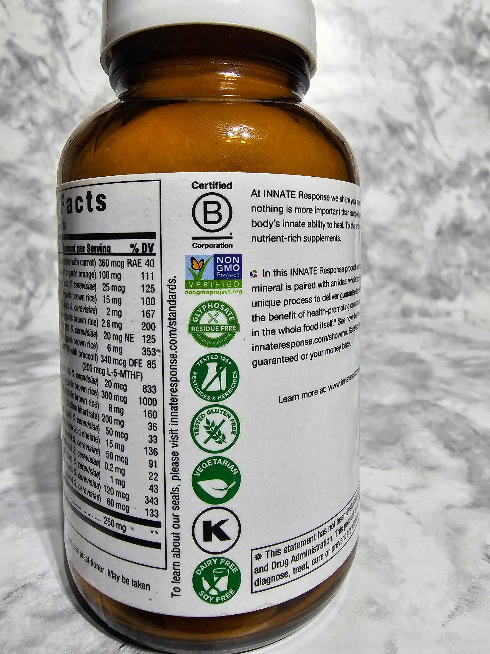 Bottle label with certification logos on a marble surface