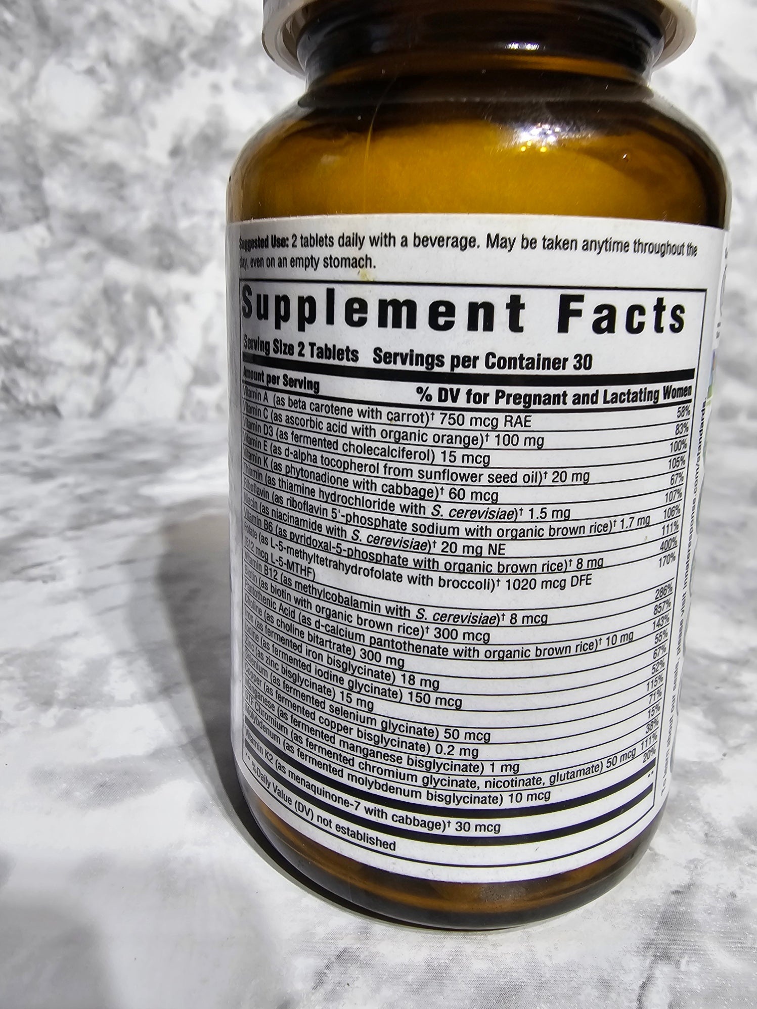 Bottle with a supplement label on a textured surface
