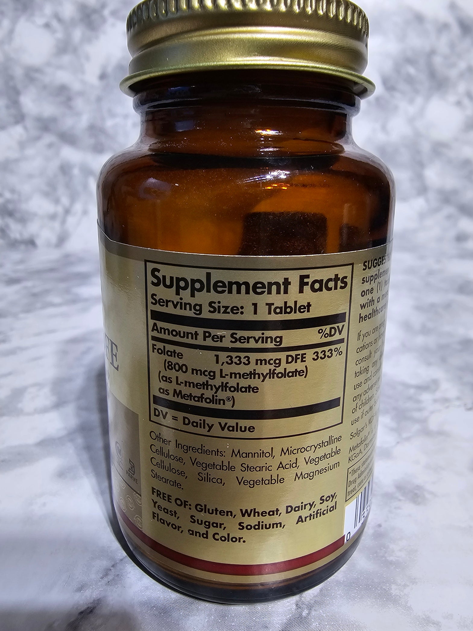 Brown supplement bottle with label on a white background