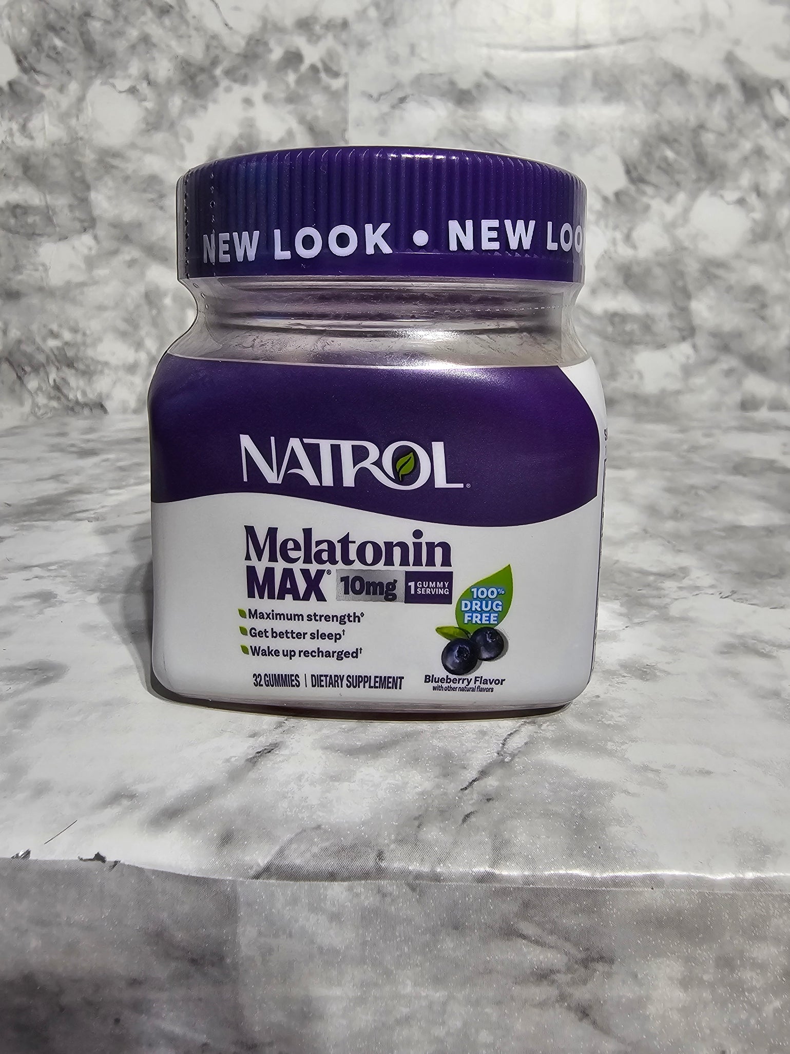 Natrol Melatonin Max supplement container on a marble surface