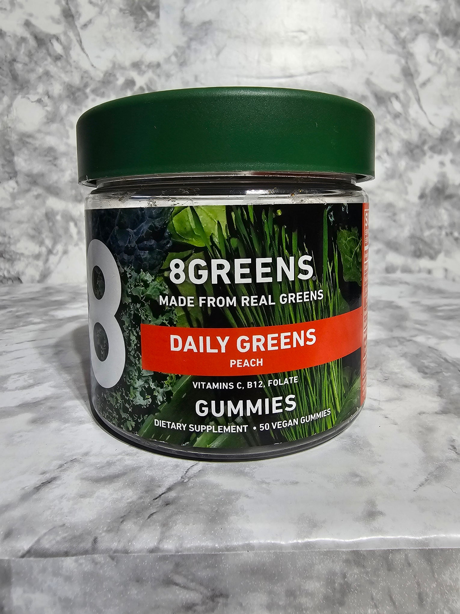 8Greens Daily Greens supplement container on a marble surface
