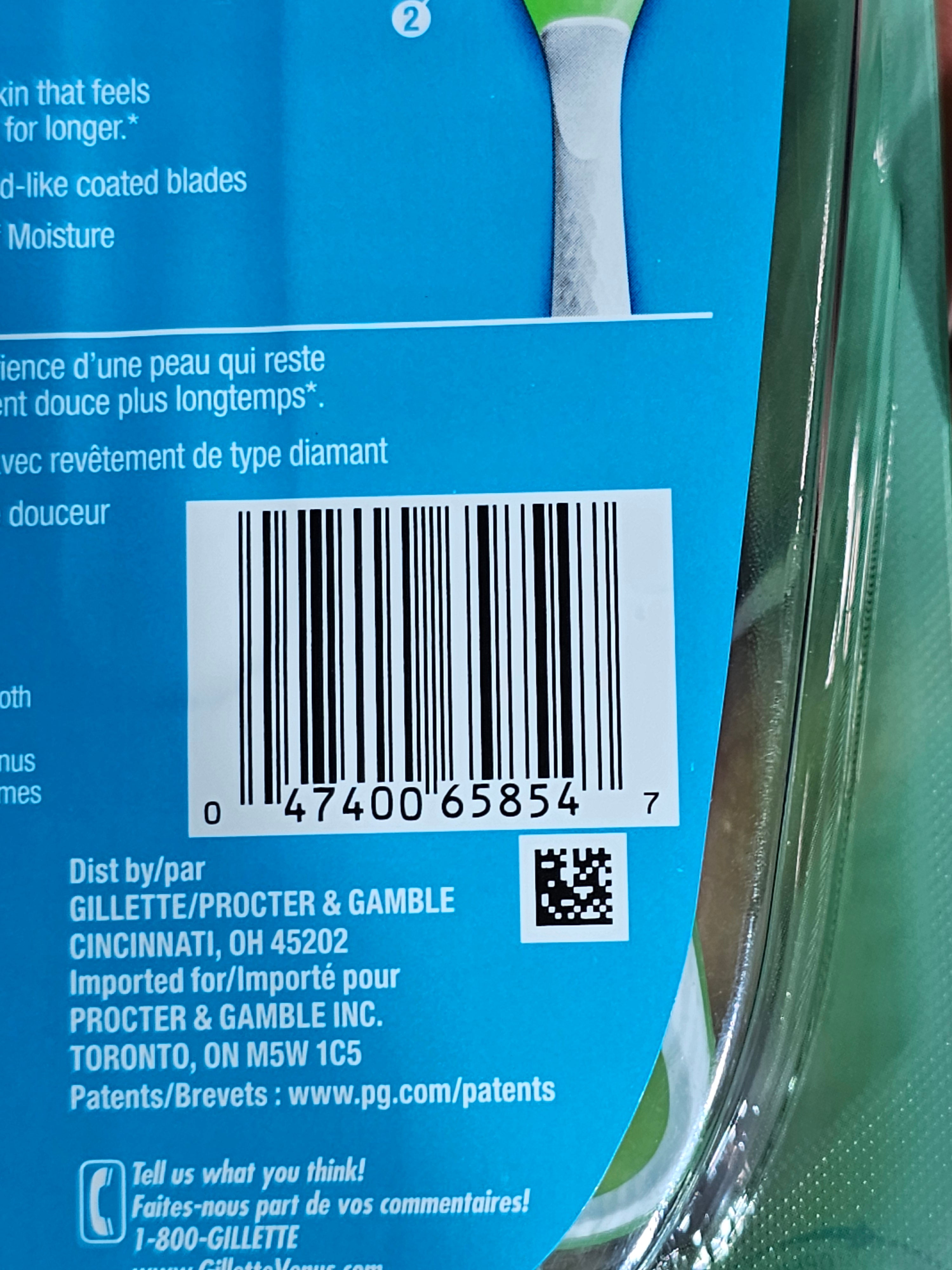 Bar code on a blue product label with visible text and a green object in the background.