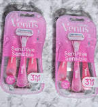 Two packages of Gillette Venus Sensitive razors on a marble surface