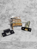 Baldwin 5510.102 latch, dark T-strike, spindle and box showing the model label