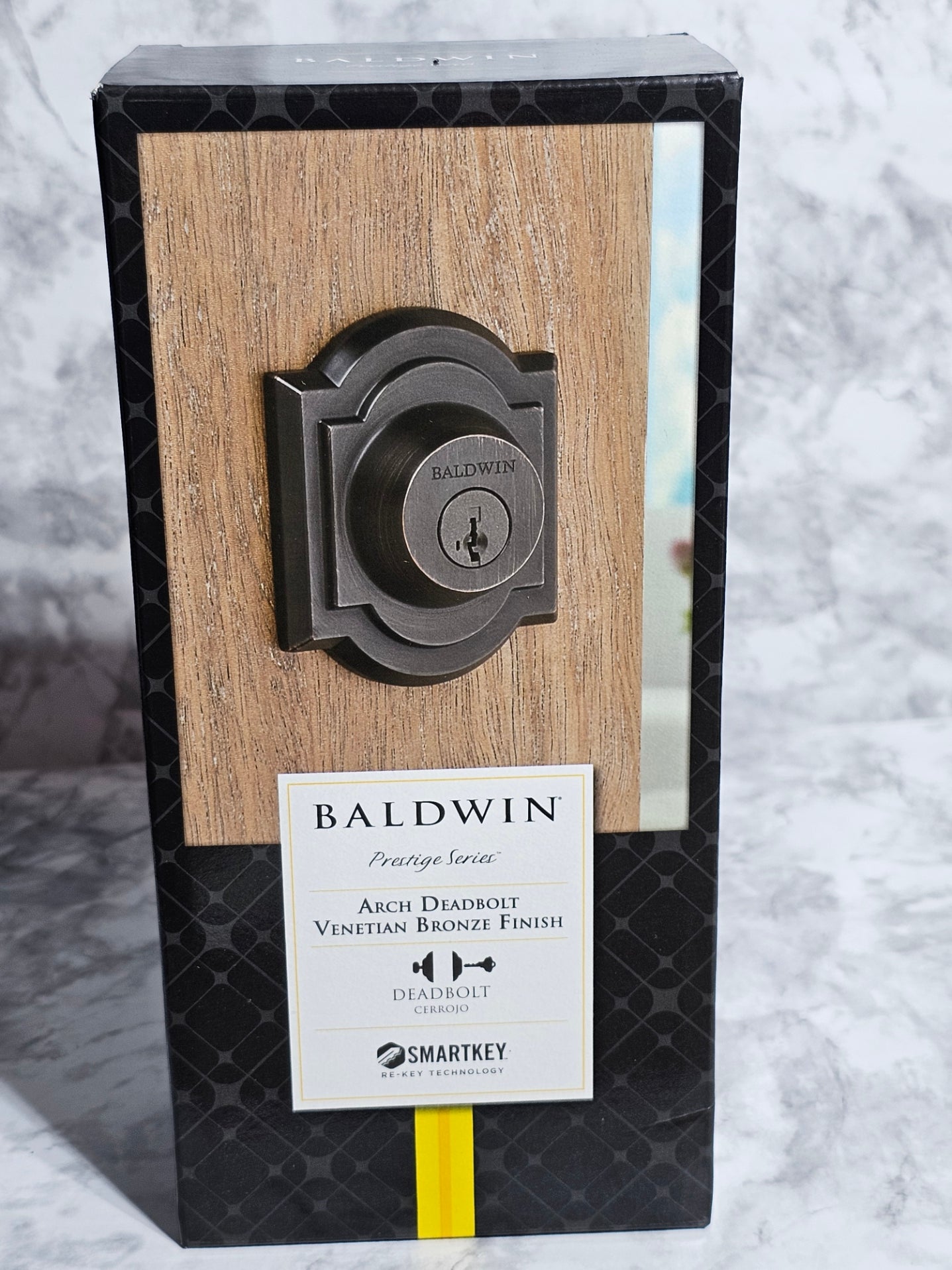 Baldwin door handle on a wooden panel with packaging