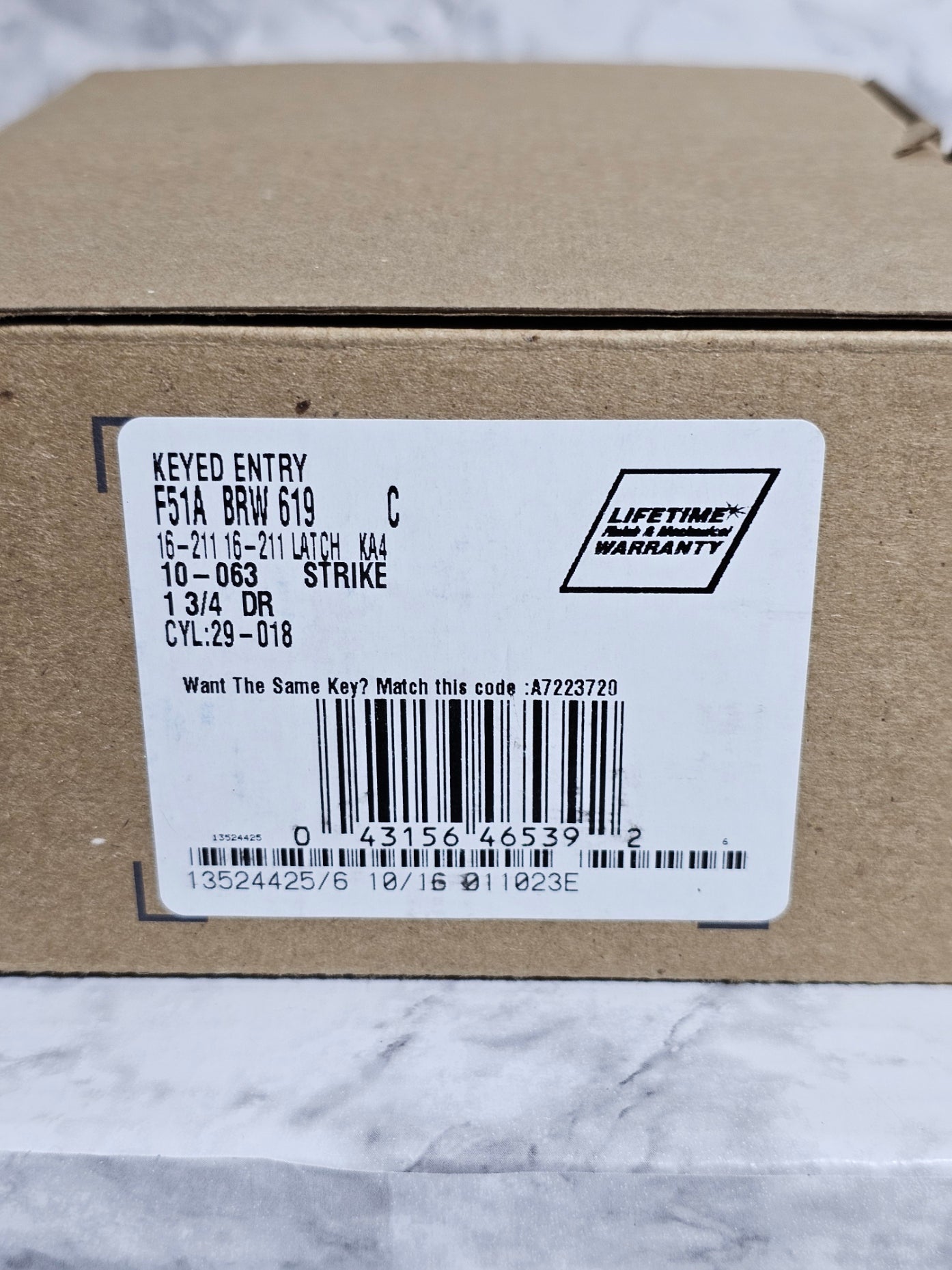 Close-up of a barcode label on a cardboard box with a white background.